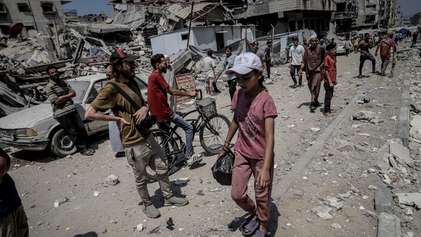 a child walking in a destroyed area