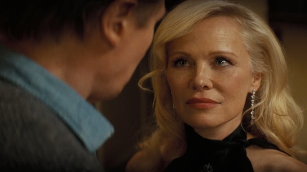 Liam Neeson plays Frank Drebin Jr. and Pamela Anderson plays Beth Davenport in The Naked Gun from Paramount Pictures.