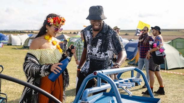 Festival goers filling up reusable bottles at a water station