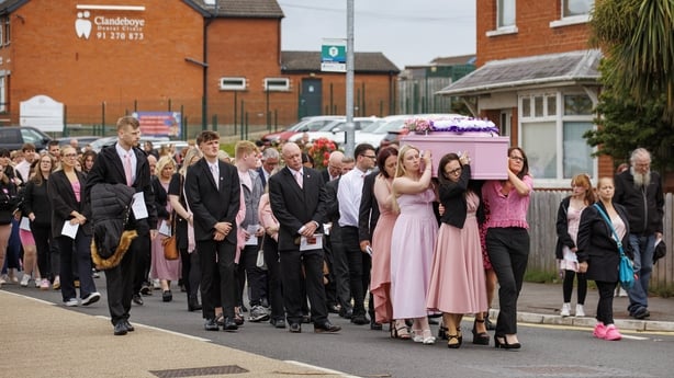 a group of people walking down a street
