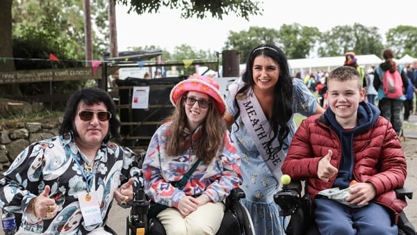 a group of people posing for a photo during festival preparations