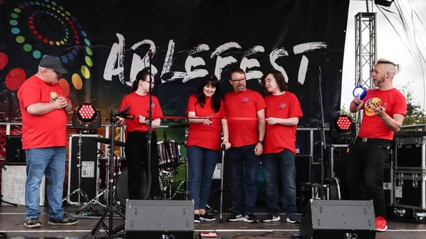 a group of people on stage during festival preparations