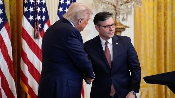 Donald Trump shakes hands with US House Speaker Mike Johnson