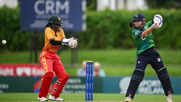 Ireland batter Amy Hunter plays a shot, watched by Zimbabwe wicketkeeper Chiyedza Teresia Dhururu, during match three of the Women's T20 International Series between Ireland and Zimbabwe at Sydney Parade in Dublin.
