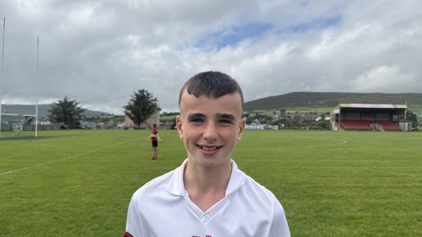 Cian Murphy stands on a gaelic pitch.