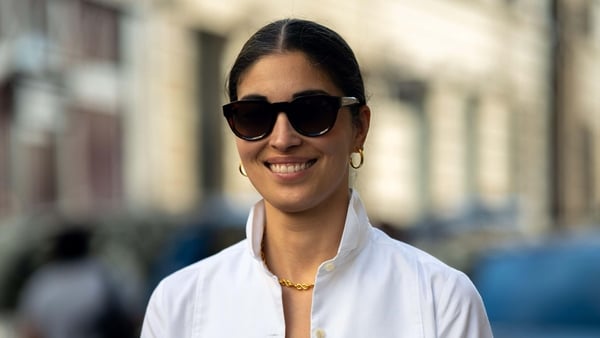 a person wearing sunglasses and a white shirt