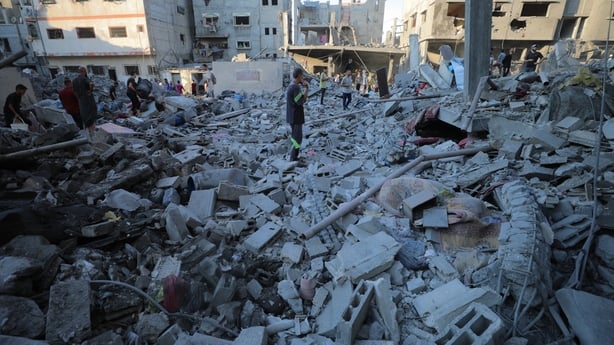 Palestinians inspect the rubble of residential buildings after Israeli warplanes targeted a residential area in the Al Bureij Refugee Camp in the central Gaza 