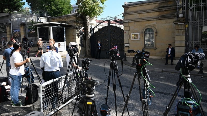 Members of the press wait outside the Iranian consulate in Istanbul, Turkey