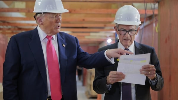 Photo shows Donald Trump pointing at a piece of paper held by Jerome Powell during a disagreement over Federal Reserve renovation costs