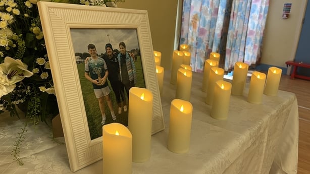 A framed picture of Vanessa Whyte and her children Sara and James surrounded by candles