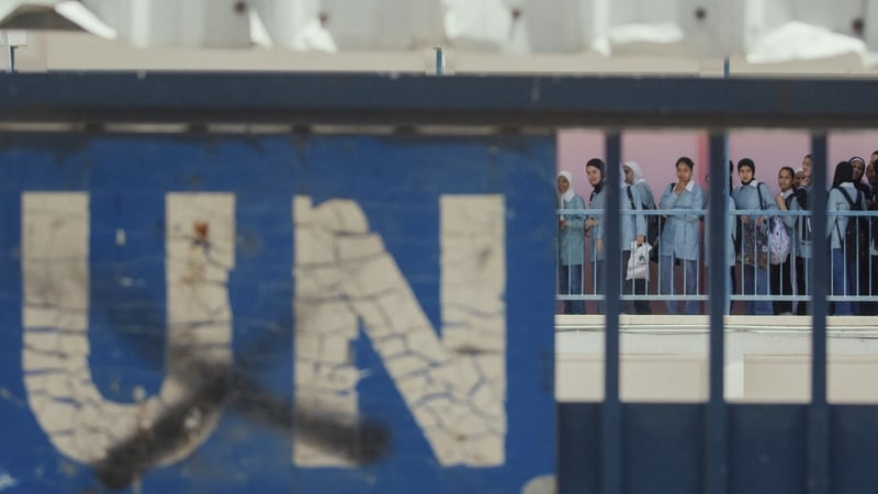 A "UN" sign is seen on a gate as students gather in an UNRWA school during a military raid in Nablus, West Bank