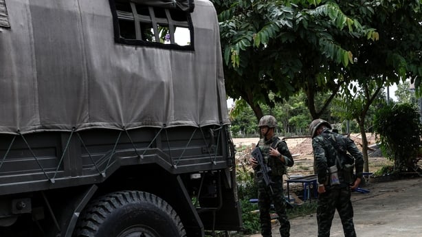 a group of soldiers standing next to a truck