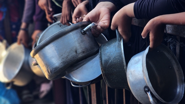 a group of people holding pots