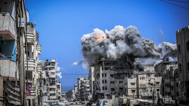 An explosion hits a building in Gaza following an Israeli attack