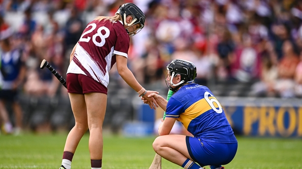 26 July 2025; Mairead Eviston of Tipperary is consoled by Niamh Niland of Galway after the Glen Dimplex All-Ireland Camogie Senior Championship semi-final match between Galway and Tipperary at UPMC Nowlan Park, Kilkenny. Photo by Ben McShane/Sportsfile