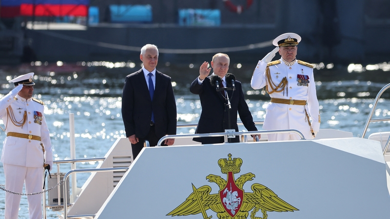 Russian President Vladimir Putin waves to crowds during Russia's Navy Day in Saint Petersburg last July