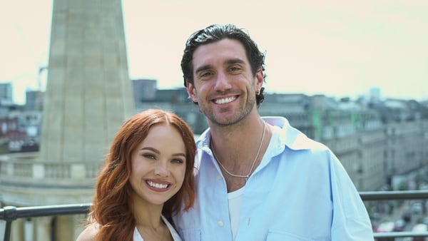 a person and person standing on a balcony