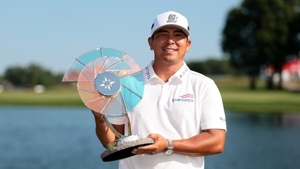 Kurt Kitayama of the United States poses with the Elemental Swing trophy after putting in to win on the 18th green during the final round of the 3M Open 2025 at TPC Twin Cities on July 27, 2025 in Blaine, Minnesota.