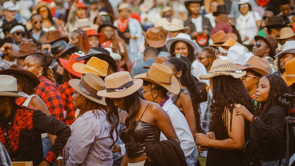 People wearing cowboy hats dance to the music at the International Cowboy Day at Ngong race course in Nairobi, Kenya
