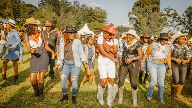 Revellers line dance during the International Cowboy Day at Ngong race course in Nairobi