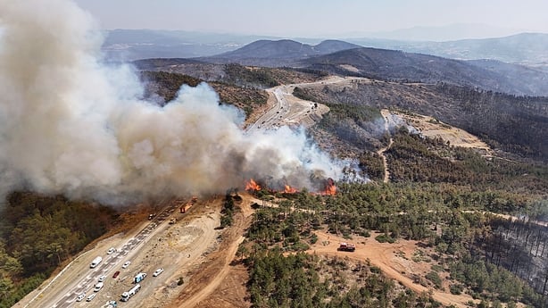 BURSA, TURKIYE - JULY 28: Flames and thick smoke rise from a wildfire in the Orhaneli district of Bursa, Turkiye, as firefighters battle to bring the blaze under control on its third day on July 28, 2025. Strong winds have hindered containment. (Photo by Mustafa Bikec/Anadolu via Getty Images)