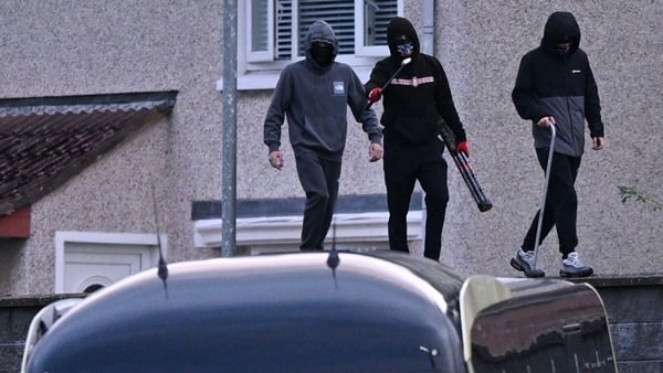 Masked members of the public walk along the perimeter of the stadium during the SSE Airtricity Men's Premier Division match between Derry City and Bohemians at The Ryan McBride Brandywell Stadium in Derry