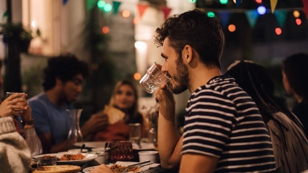 man drinking water at an outdoor party in summer