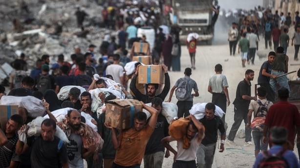 Palestinians gather at an aid distribution point in Gaza