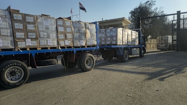 Aid trucks carrying essential supplies passing through the Rafah Border Crossing into the Gaza