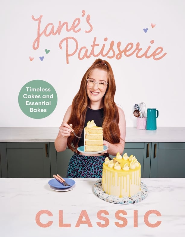 a person holding a plate of cake