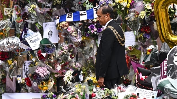 Lord Mayor of Birmingham, Councillor Zafar Iqbal, views the tributes prior to Ozzy Osbourne's funeral cortège traveling through his home city of Birmingham on 30 July, 2025