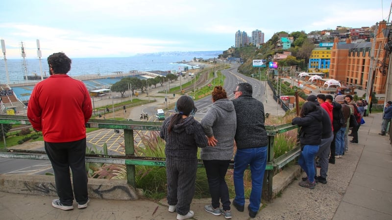 Citizens of the port of Valparaiso in Chile look at the sea during an evacuation plan due to a tsunami alert