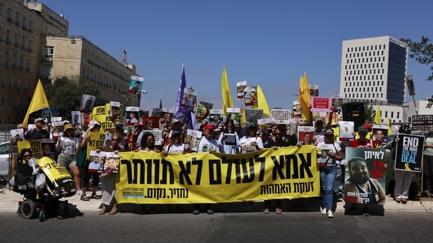 Group of people hold flags and banners in Tel Aviv