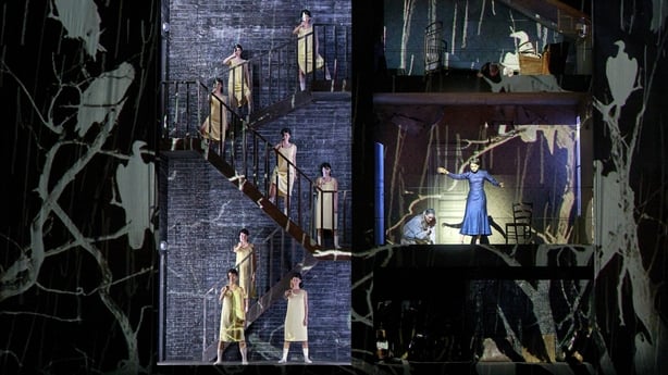 Women holding knives standing on zigzag stairs