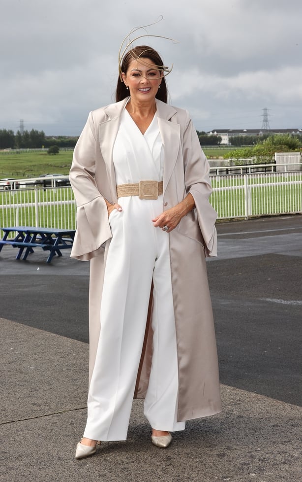 a woman in a white jumpsuit