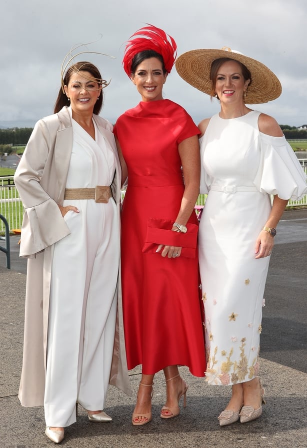 a group of women wearing dresses and hats