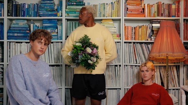 a group of men in a room with bookshelves