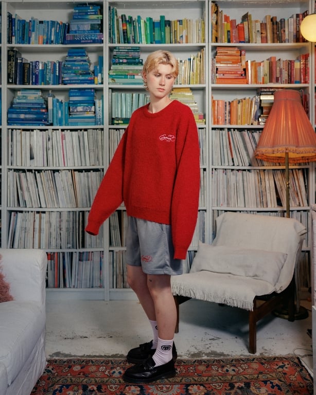 a person standing in front of a bookcase