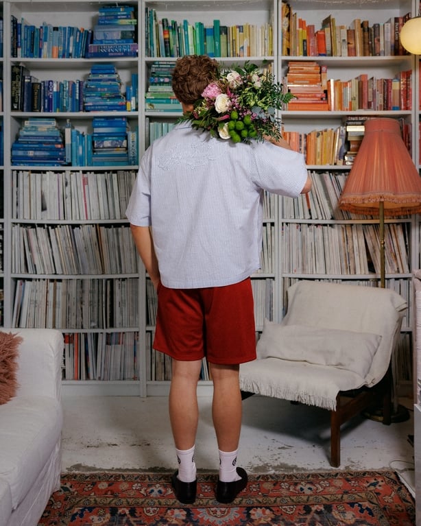 a person with a bouquet of flowers on his back