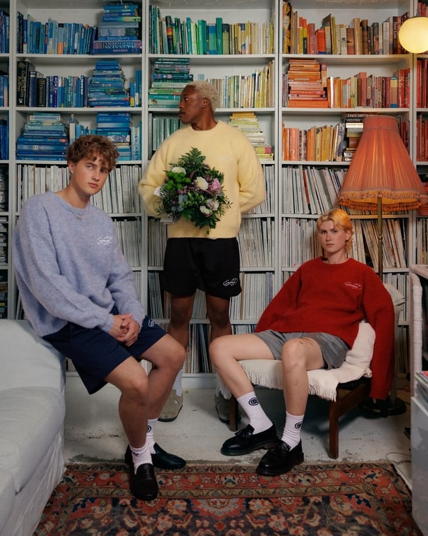 a group of men in a room with bookshelves