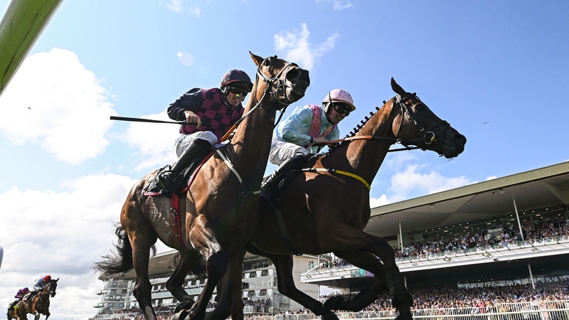 Ndaawi, left, with Jack Kennedy up, crosses the line to win the Guinness Galway Hurdle Handicap from Helvic Dream following a steward's enquiry