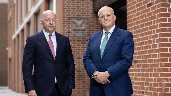 AIB CEO Colin Hunt and chief financial officer Donal Galvin with the AIB logo behind them