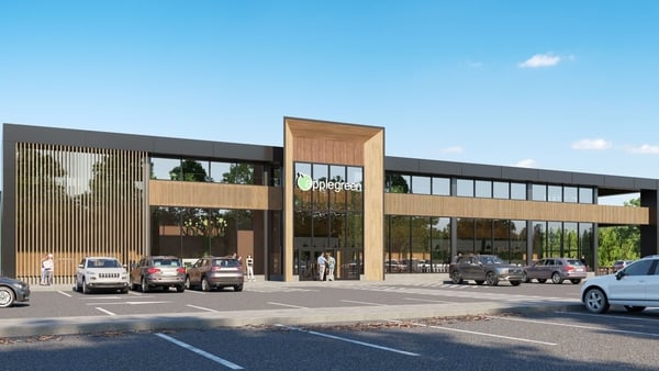 An artist's impression of a new Applegreen services facility in the US with cars parked outside a building