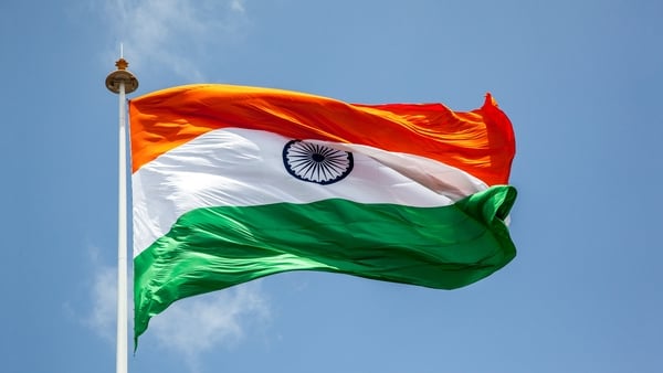 Indian tricolor flag flying high in Pune, India.