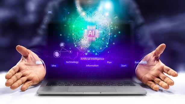 A man holding a laptop with a computer generated image of a brain and the AI symbol 