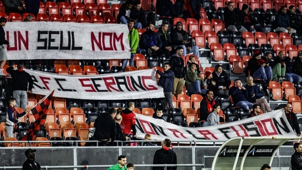 a group of people holding banners in a stadium