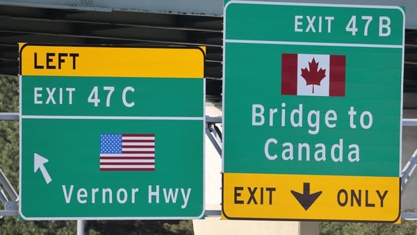 A sign on Interstate 75 directs motorists to Detroit or Canada, near the Ambassador Bridge in Detroit, Michigan