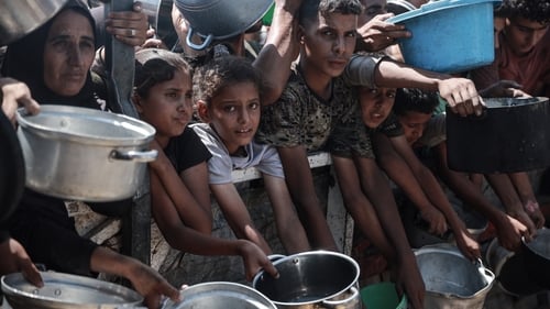 Palestinians wait for food aid as UN-backed experts warn Gaza is slipping into famine