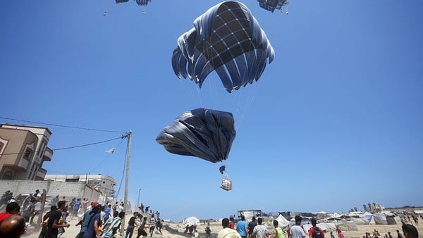 A plane drops humanitarian aid as efforts continue to airdrop supplies by parachute into Gaza Strip