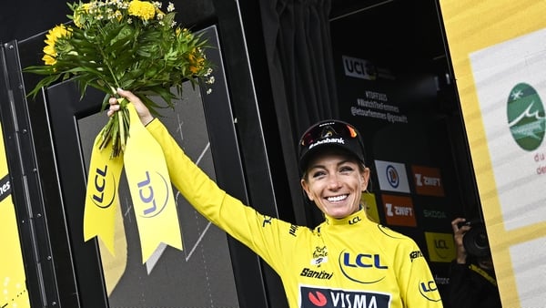 Team Visma | Lease a Bike's French rider Pauline Ferrand-Prevot wearing the overall leader's yellow jersey celebrates on the podium after winning the 8th stage (out of 9) of the fourth edition of the Women's Tour de France cycling race, 111.9 km from Cham